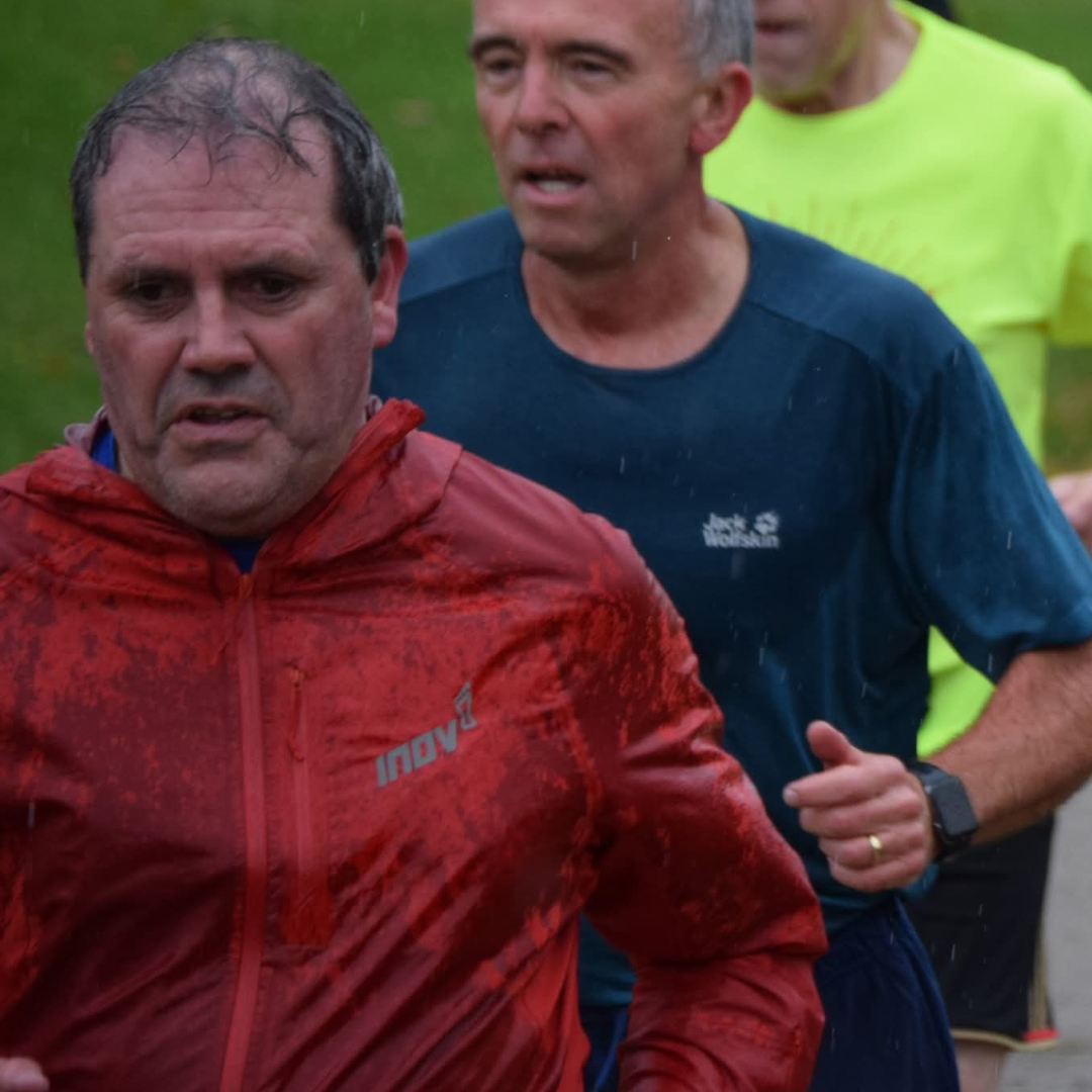 A picture of Brian running in the rain.